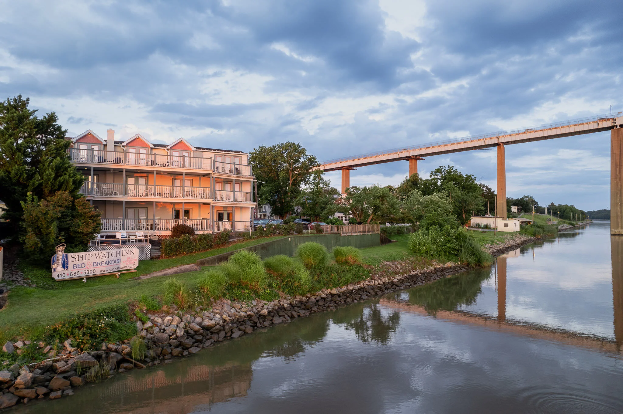 Ship Watch Inn as viewed from the water with the Chesapeake City Bridge visible in the background
